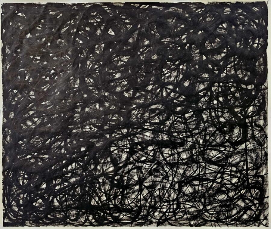 Loose black scribbled loops layered into a heavy mass that gathers toward the right side of the sheet.