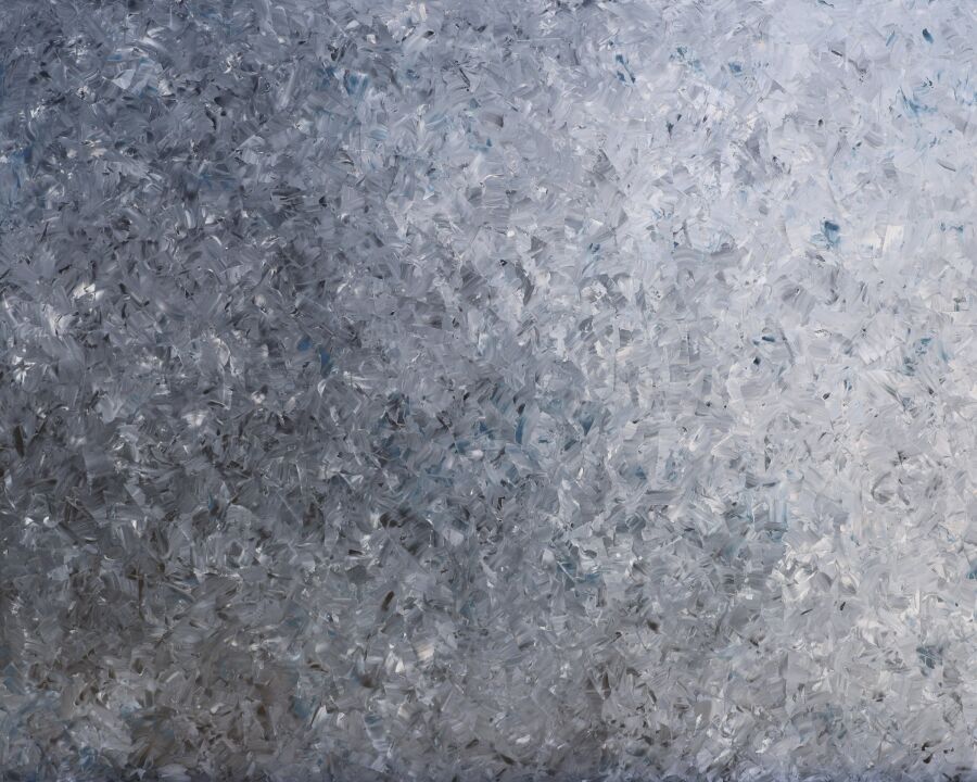 Pale silver and blue-white surface built from small overlapping strokes, like frost or shattered ice.