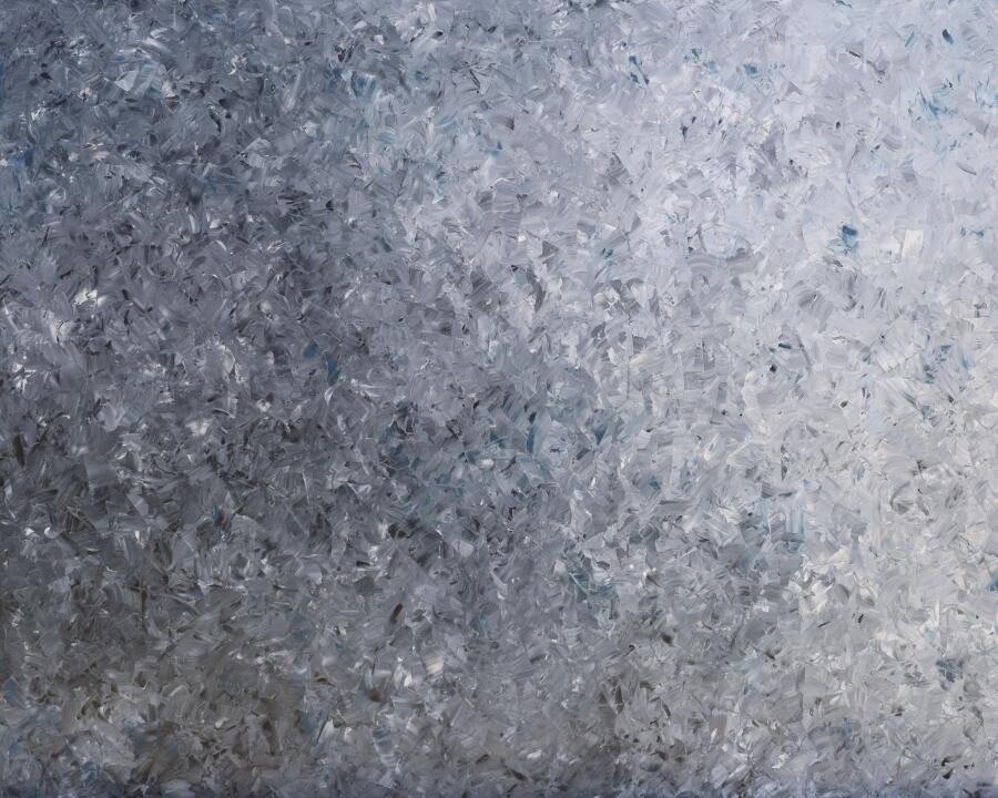 Pale silver and blue-white surface built from small overlapping strokes, like frost or shattered ice.
