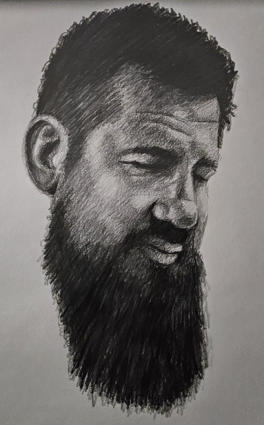 Charcoal self-portrait by Josh Niccolai-Belfi, bearded, looking down and to one side