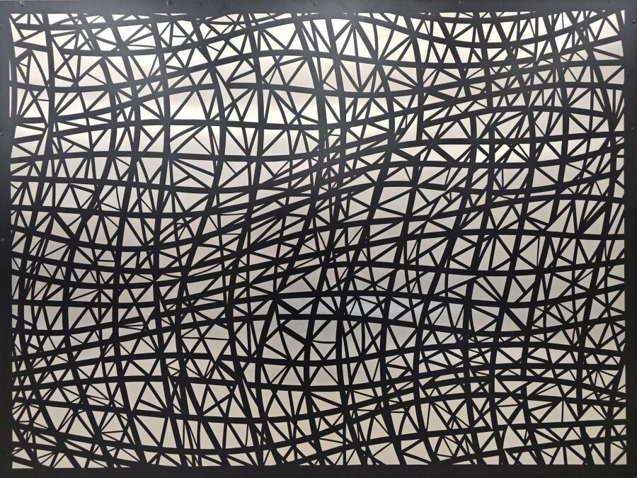 Aluminum panel covered in a web of straight black lines crossing at sharp angles over a pale ground.